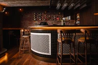 Miss Gunn's Basement Bar logo