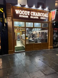 Woody Charcoal logo